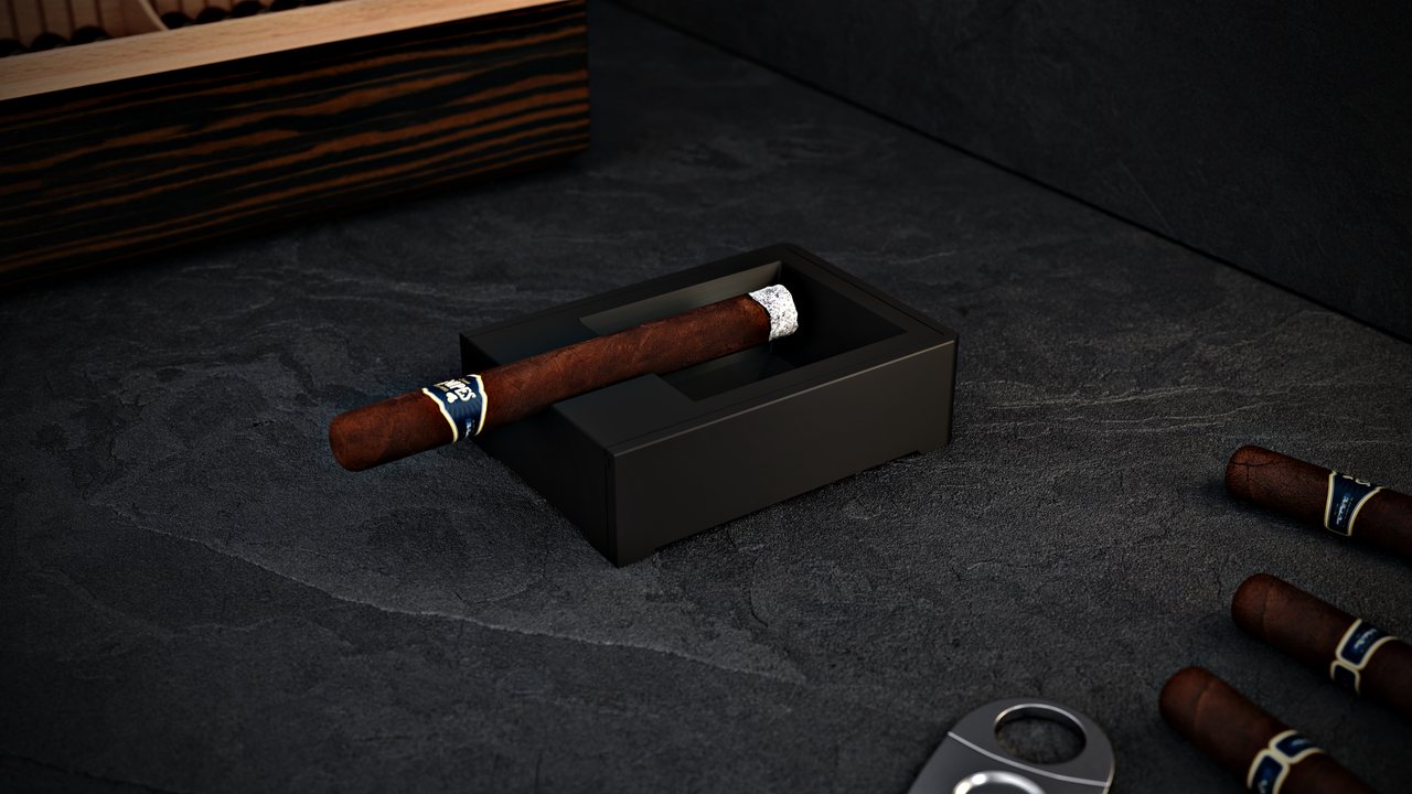 Fortress in black on the same table, with cigars and a cutter alongside